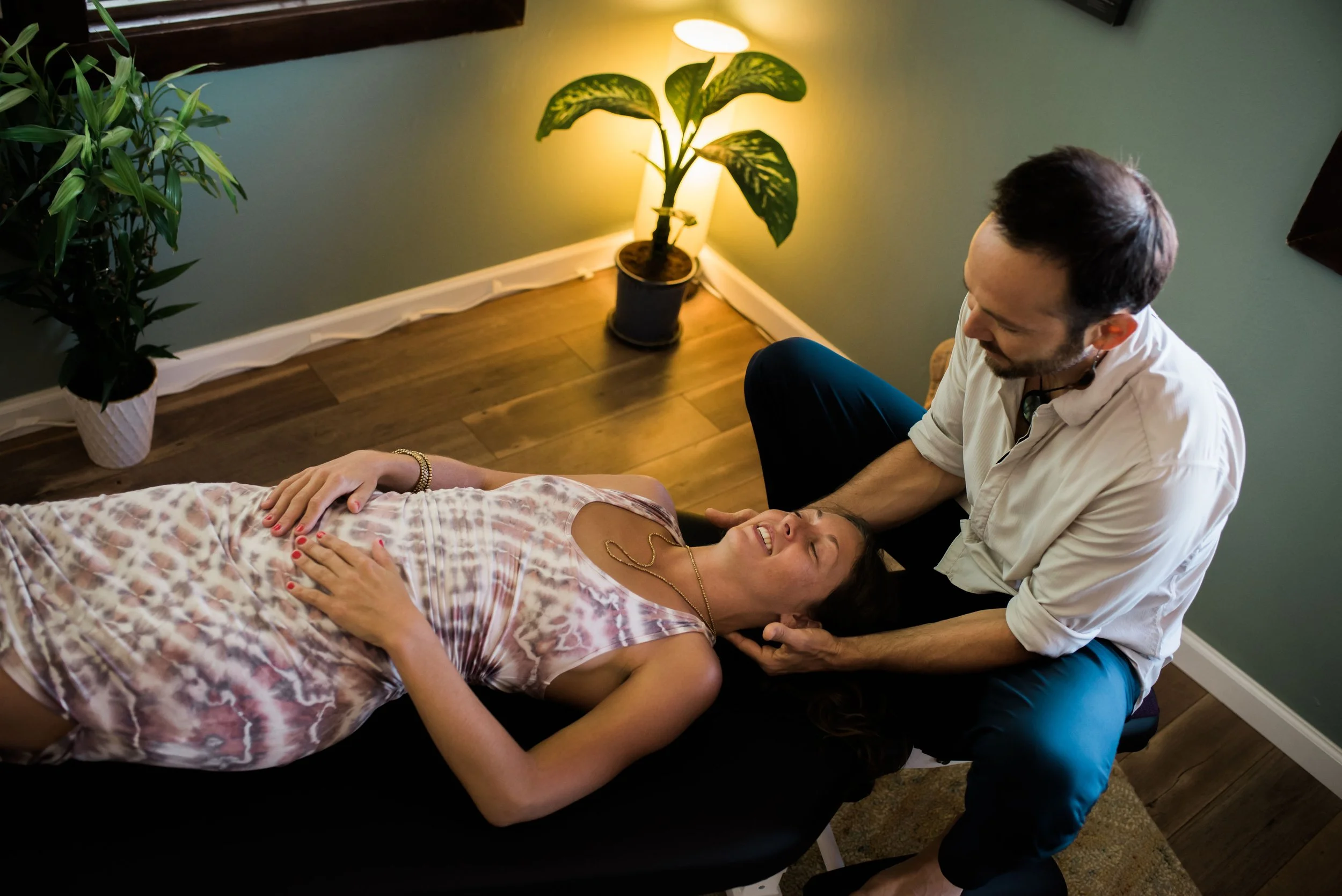 Dr. Dylan performing gentle neck adjustment during Network Chiropractic session